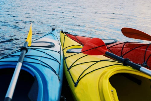 Blue, yellow and red kayak's floating in the sea