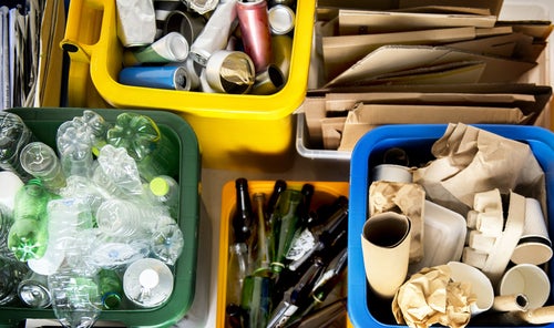 Recycling organised in to groups of cans, cardboard, glass and-plastics
