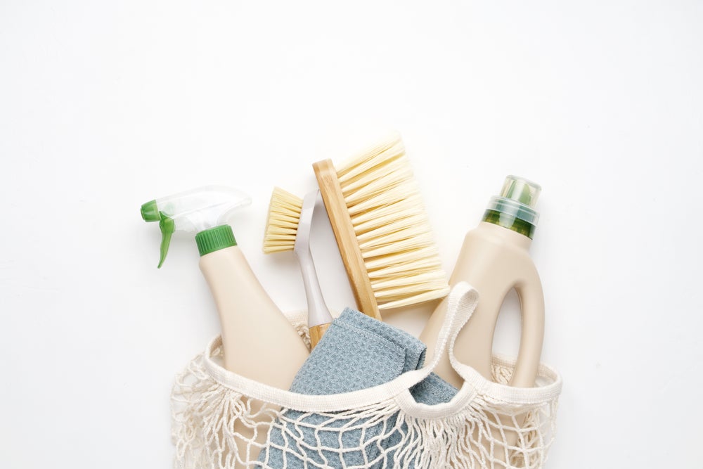 Eco cleaning brushes and rag on white background