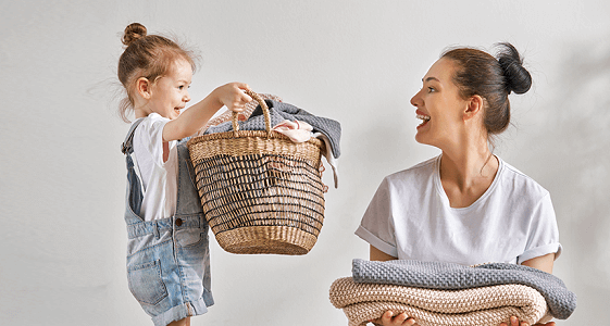 Mum and daughter doing the laundry together