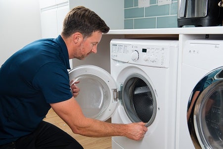 Domestic and General engineer repairing a washer dryer