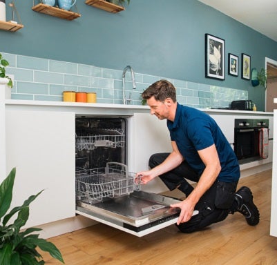Male D&G engineer fixing a dishwasher
